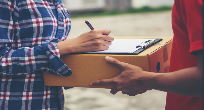 Man is checking the list for Next day courier London
