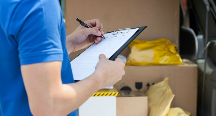 Knighthak delivery man checking the list of same day courier London packages