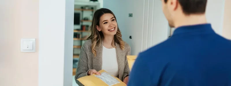 Happy woman taking package from knighthak courier delivery boy